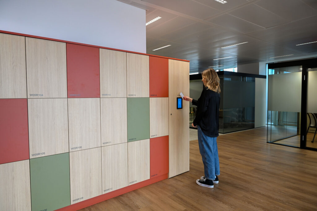 Employee accessing smart locker with card reader